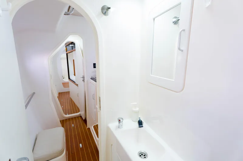 Osprey Yacht Photos Pics Interior of 2010 Voyage 520 yacht with sleek white bathroom and wooden flooring.