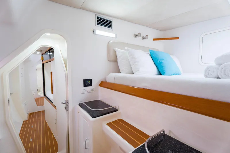 Osprey Yacht Photos Pics Luxurious cabin interior of 2010 Voyage 520 yacht with modern amenities and cozy bedding.