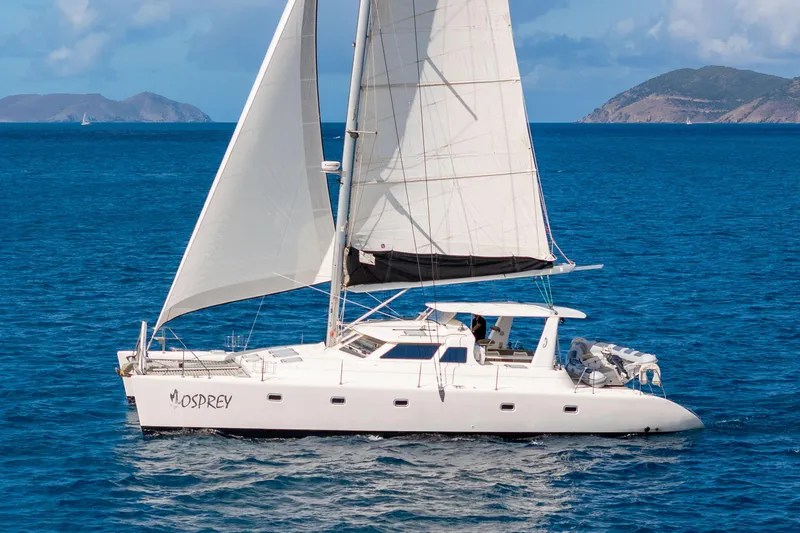 Osprey Yacht Photos Pics Sailing catamaran Voyage 520, 2010 model, cruising in clear blue ocean waters.