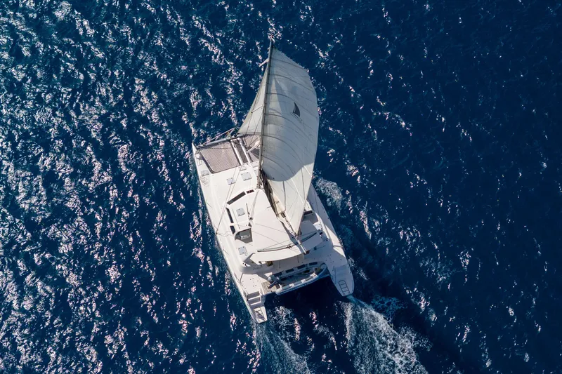 Osprey Yacht Photos Pics Aerial view of 2010 Voyage 520 sailboat navigating blue ocean waters.