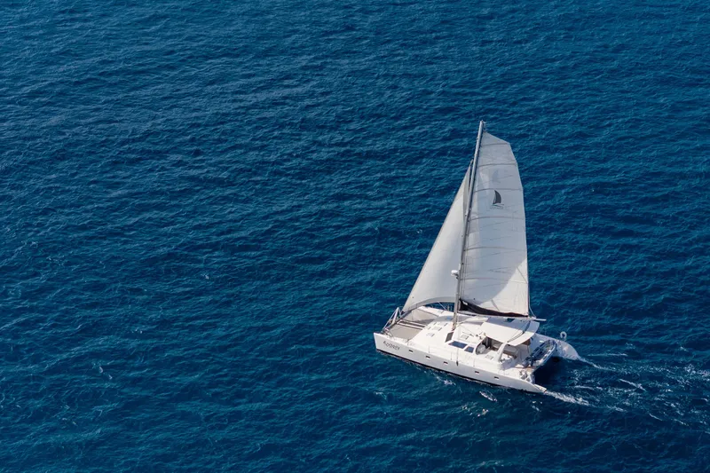 Osprey Yacht Photos Pics Aerial view of 2010 Voyage 520 sailboat navigating blue ocean waters.