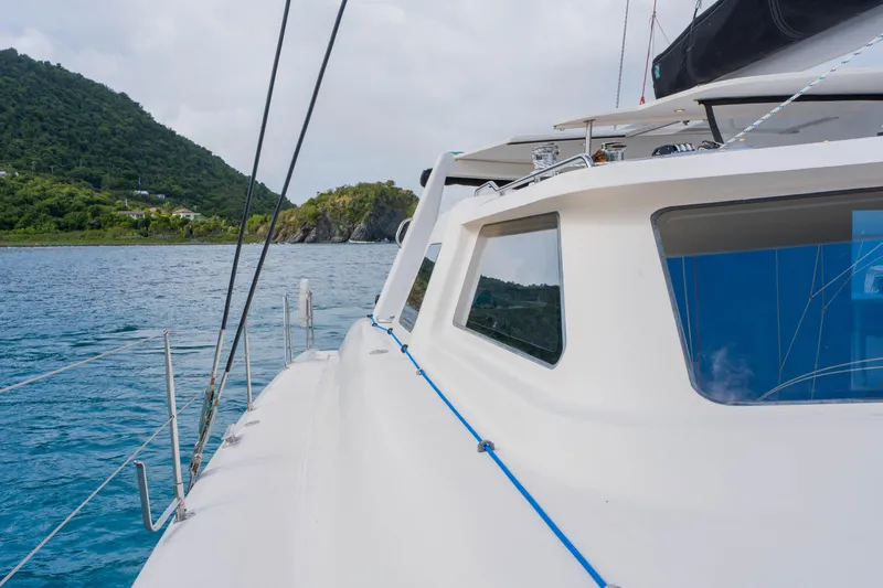 Osprey Yacht Photos Pics Sailing yacht Voyage 520, 2010 model, cruising near lush green island coast.