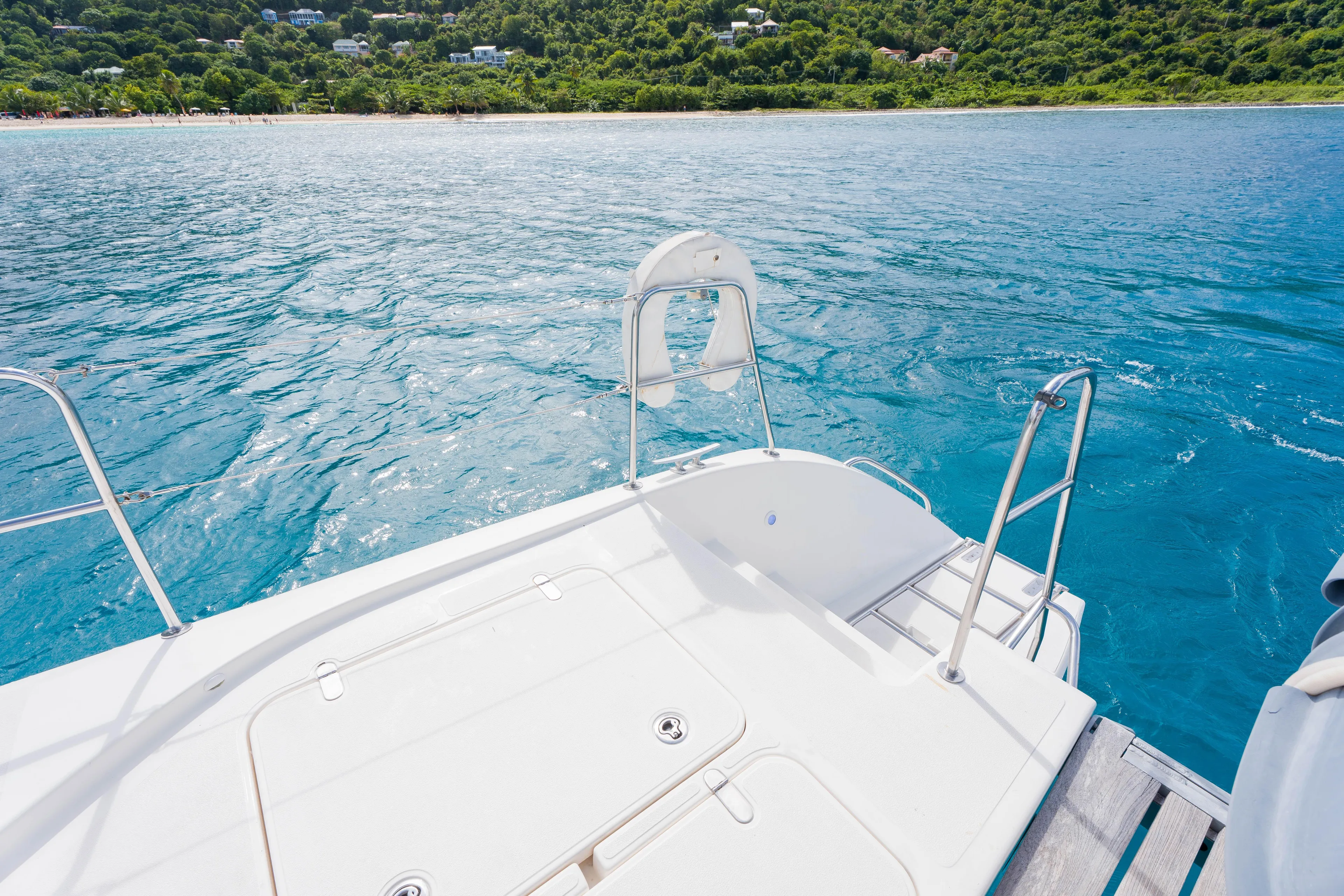 Osprey Yacht Photos Pics Sailing on a 2010 Voyage 520 yacht near a lush, green coastline.