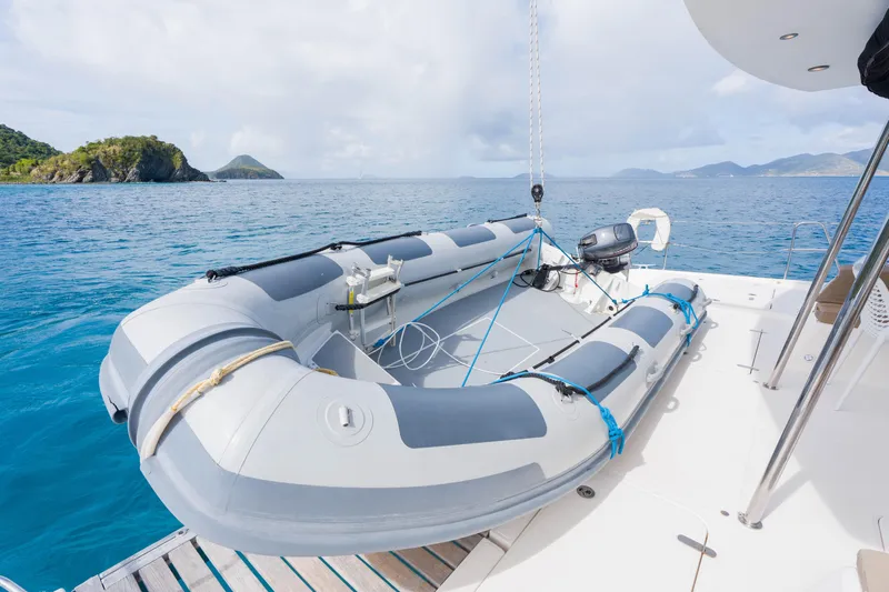 Osprey Yacht Photos Pics Inflatable boat on Voyage 520 yacht, 2010 model, with scenic ocean and island backdrop.