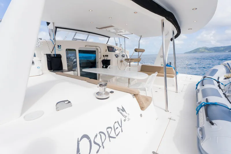 Osprey Yacht Photos Pics Luxurious 2010 Voyage 520 yacht deck with seating, table, and ocean view.