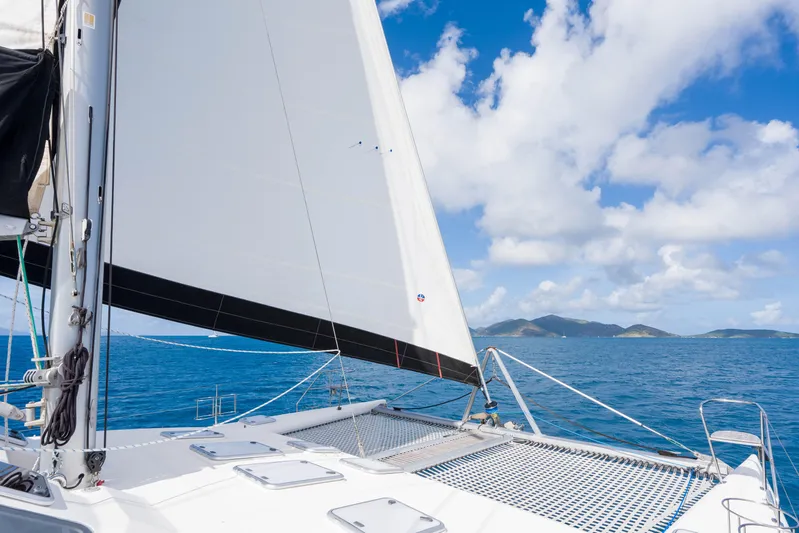 Osprey Yacht Photos Pics Sailing on a 2010 Voyage 520 catamaran in clear blue ocean under a sunny sky.