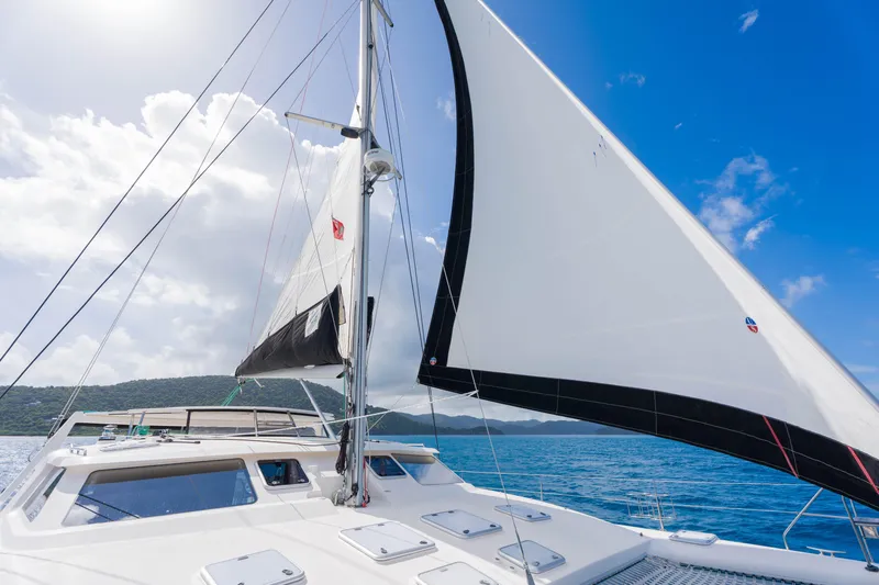 Osprey Yacht Photos Pics Sailing on a 2010 Voyage 520 catamaran under clear blue skies and calm sea.