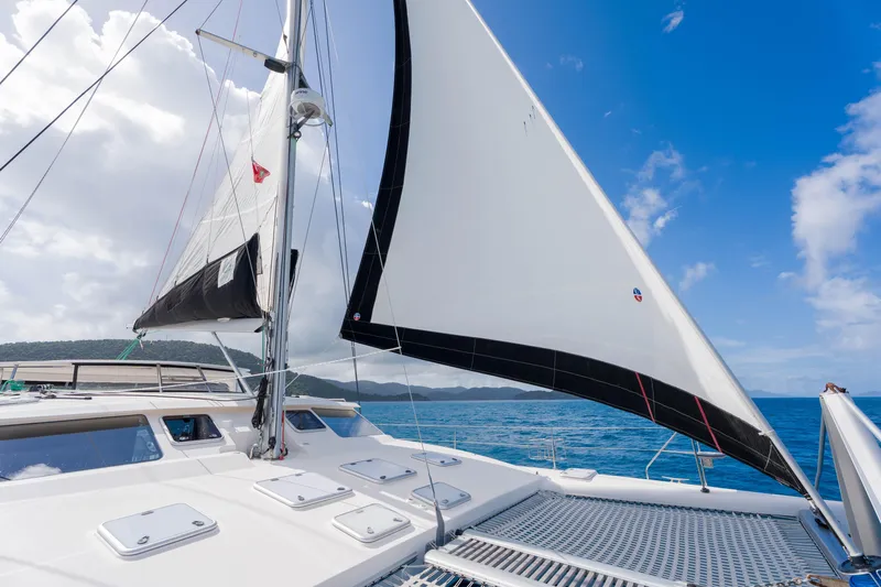 Osprey Yacht Photos Pics Sailing on a 2010 Voyage 520 catamaran with white sails against a blue sky.
