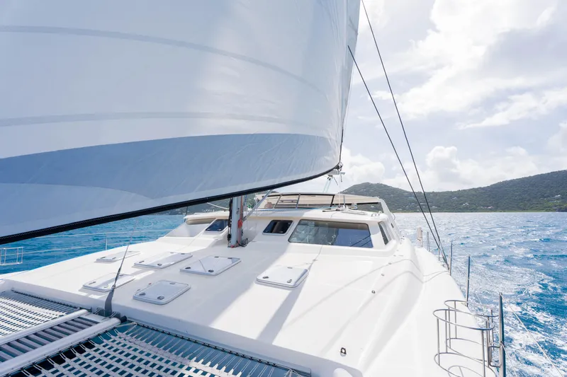 Osprey Yacht Photos Pics Sailing on a 2010 Voyage 520 catamaran in clear blue waters under a sunny sky.