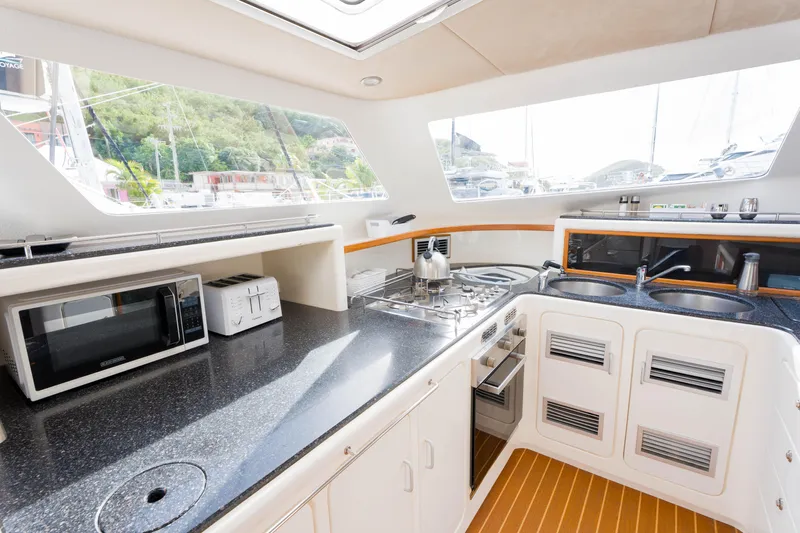 Osprey Yacht Photos Pics Modern kitchen in 2010 Voyage 520 yacht with appliances and sleek countertops.