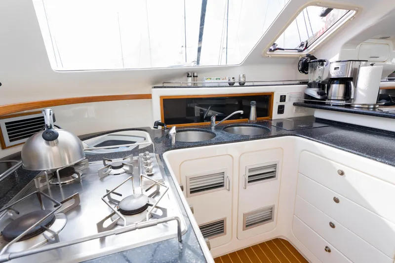 Osprey Yacht Photos Pics Modern kitchen in 2010 Voyage 520 yacht with stove, sink, and appliances.