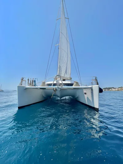  Yacht Photos Pics 2018 Lagoon 620 catamaran sailing on clear blue water under a bright sky.