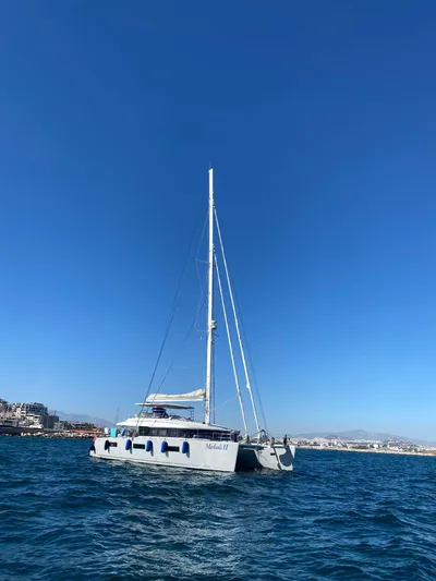  Yacht Photos Pics 2018 Lagoon 620 catamaran sailing on clear blue waters under a bright sky.