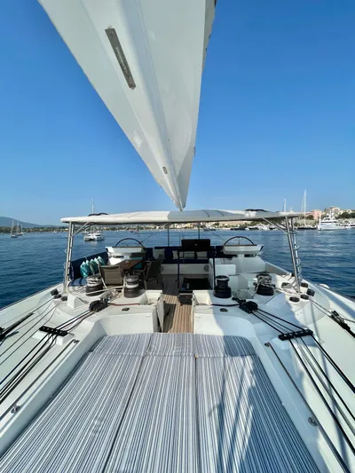  Yacht Photos Pics Lagoon 620 yacht deck, 2018 model, sailing on calm blue waters under clear skies.