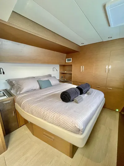  Yacht Photos Pics Luxurious cabin interior of 2018 Lagoon 620 yacht with cozy bed and modern design.