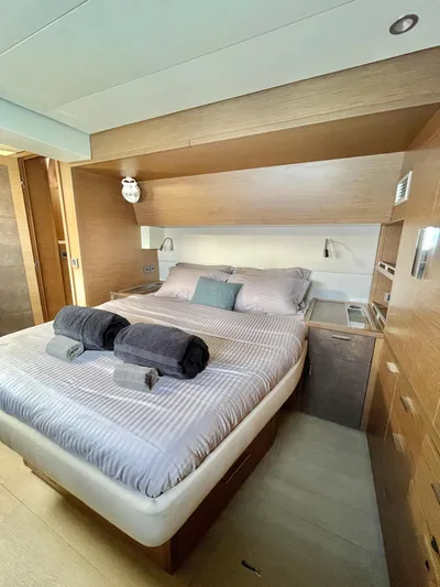  Yacht Photos Pics Luxurious cabin interior of 2018 Lagoon 620 yacht with cozy bed and modern design.