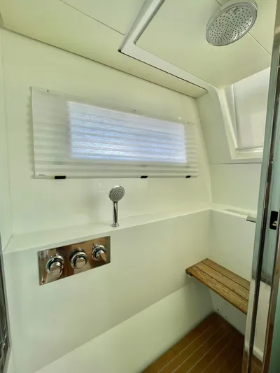  Yacht Photos Pics Luxurious Lagoon 620 2018 yacht shower with modern fixtures and wooden bench.