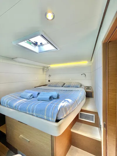  Yacht Photos Pics Luxurious cabin interior of 2018 Lagoon 620 yacht with cozy bed and modern design.