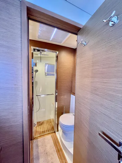  Yacht Photos Pics Luxurious bathroom in 2018 Lagoon 620 yacht with modern fixtures and wooden accents.