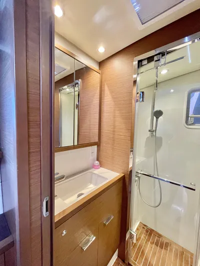  Yacht Photos Pics Luxurious bathroom in 2018 Lagoon 620 yacht with modern fixtures and wooden accents.