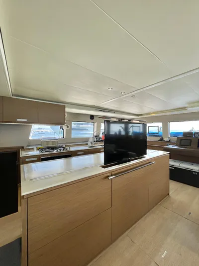  Yacht Photos Pics Luxurious interior of 2018 Lagoon 620 yacht with modern kitchen and entertainment area.