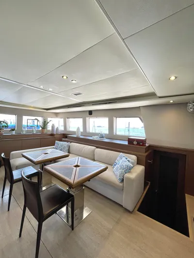  Yacht Photos Pics Luxurious interior of 2018 Lagoon 620 yacht with elegant seating and dining area.