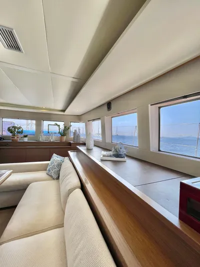  Yacht Photos Pics Interior of 2018 Lagoon 620 yacht with panoramic windows and elegant seating.
