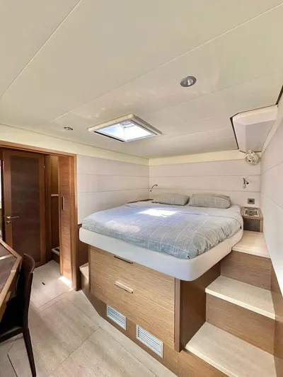  Yacht Photos Pics Luxurious cabin interior of 2018 Lagoon 620 yacht with modern design and cozy bed.