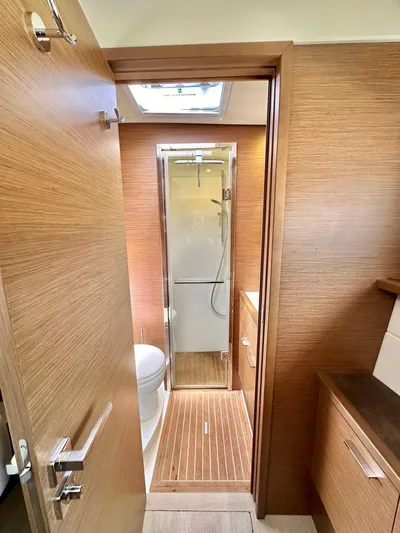  Yacht Photos Pics Luxurious bathroom in 2018 Lagoon 620 yacht with wood accents and modern shower.