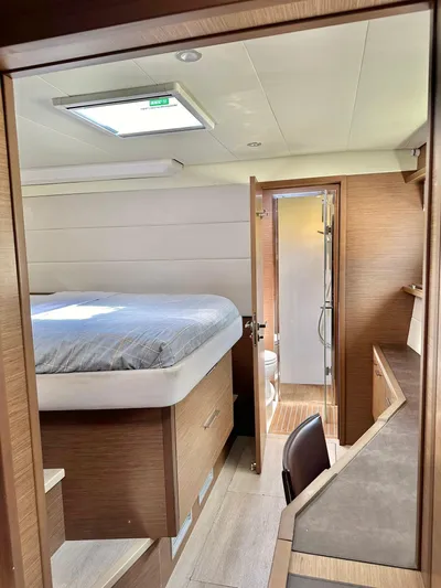  Yacht Photos Pics Luxurious interior of 2018 Lagoon 620 yacht with cozy bedroom and ensuite bathroom.