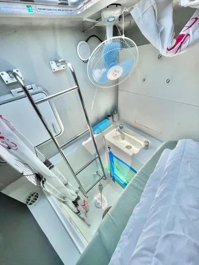  Yacht Photos Pics Compact bathroom in 2018 Lagoon 620 yacht with shower, sink, and fan.