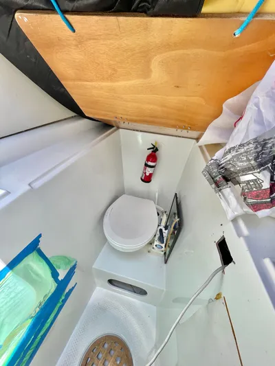  Yacht Photos Pics Lagoon 620 yacht bathroom with toilet, fire extinguisher, and wooden accents, 2018 model.