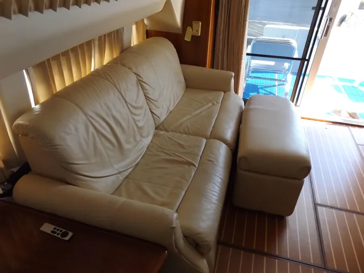  Yacht Photos Pics 2003 Carver 360 Sport Sedan interior with beige leather sofa and ottoman.