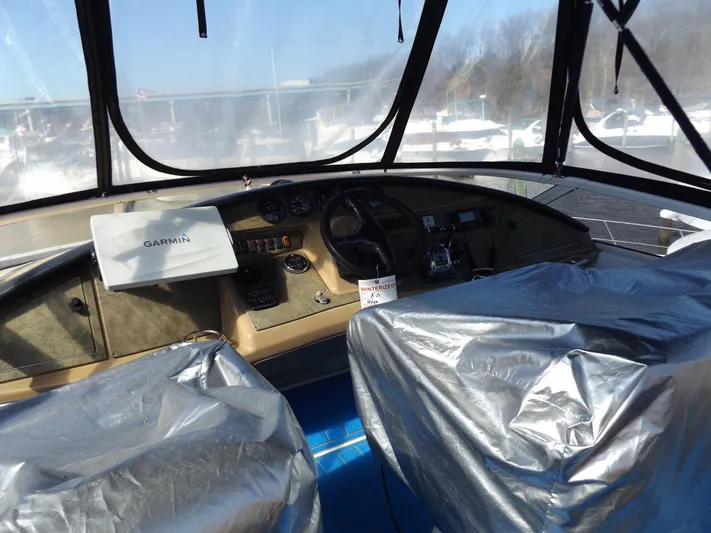  Yacht Photos Pics 2003 Carver 360 Sport Sedan cockpit with Garmin navigation, covered seats, and clear windows.