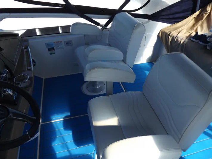  Yacht Photos Pics Interior of a 2003 Carver 360 Sport Sedan with white seats and blue flooring.