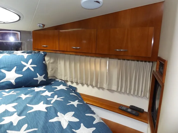  Yacht Photos Pics 2003 Carver 360 Sport Sedan cabin with starfish bedding and wooden cabinets.