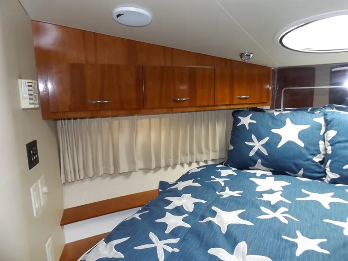  Yacht Photos Pics Interior of 2003 Carver 360 Sport Sedan with starfish bedding and wooden cabinets.