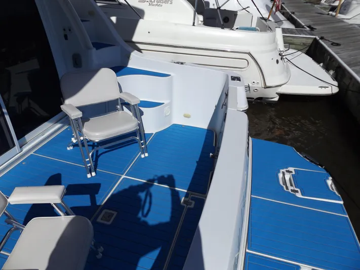  Yacht Photos Pics 2003 Carver 360 Sport Sedan with blue deck and seating at marina.