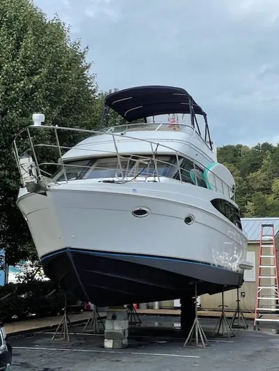  Yacht Photos Pics 2003 Carver 360 Sport Sedan yacht on stands, outdoor setting, overcast sky.