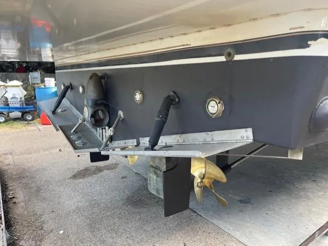  Yacht Photos Pics Rear view of a 2003 Carver 360 Sport Sedan boat with propeller and trim tabs.