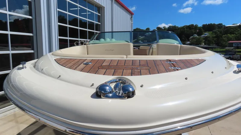  Yacht Photos Pics 2018 Chris-Craft Launch 34 boat with teak deck, docked near a modern building.