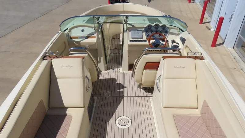  Yacht Photos Pics 2018 Chris-Craft Launch 34 boat interior with beige seating and wooden steering wheel.