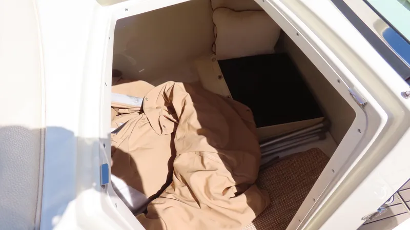  Yacht Photos Pics Storage compartment in 2018 Chris-Craft Launch 34 boat with beige cover and cushions.