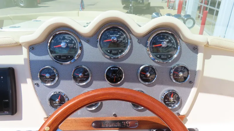  Yacht Photos Pics Dashboard of 2018 Chris-Craft Launch 34 with gauges and wooden steering wheel.
