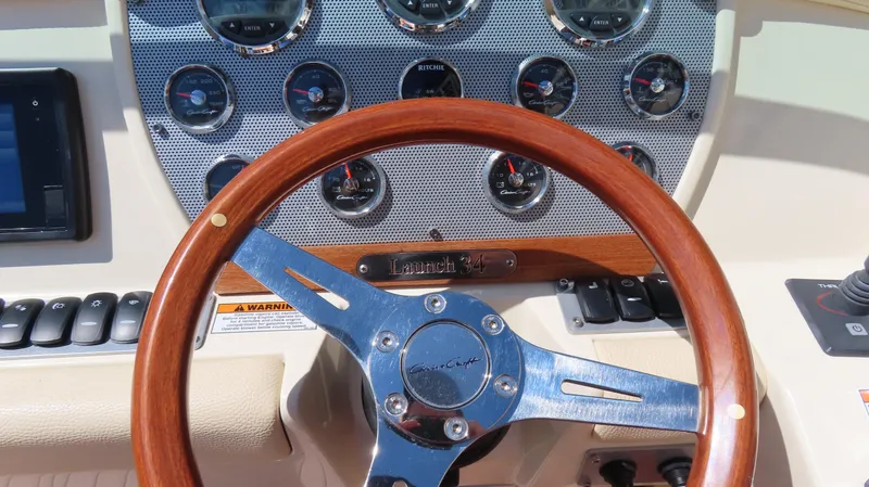  Yacht Photos Pics Dashboard of 2018 Chris-Craft Launch 34 with wooden steering wheel and gauges.