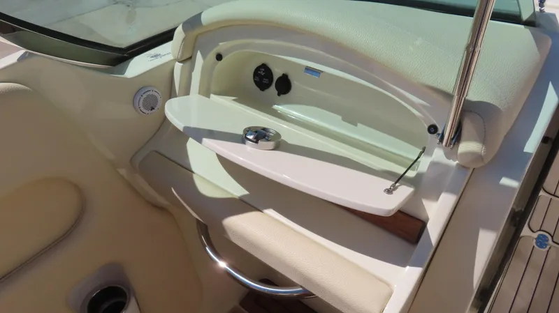  Yacht Photos Pics 2018 Chris-Craft Launch 34 interior detail with beige upholstery and storage compartment.