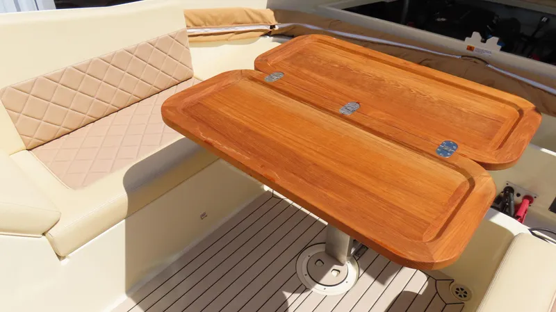  Yacht Photos Pics 2018 Chris-Craft Launch 34 interior with wooden table and beige seating.