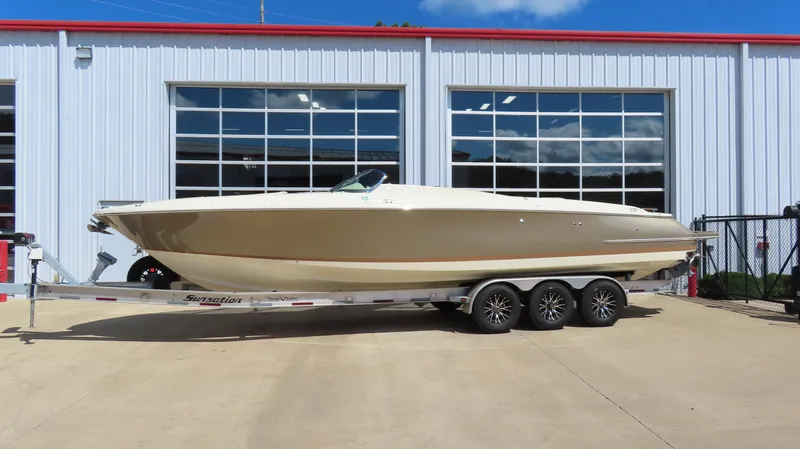  Yacht Photos Pics 2018 Chris-Craft Launch 34 boat on trailer, parked outside a building.