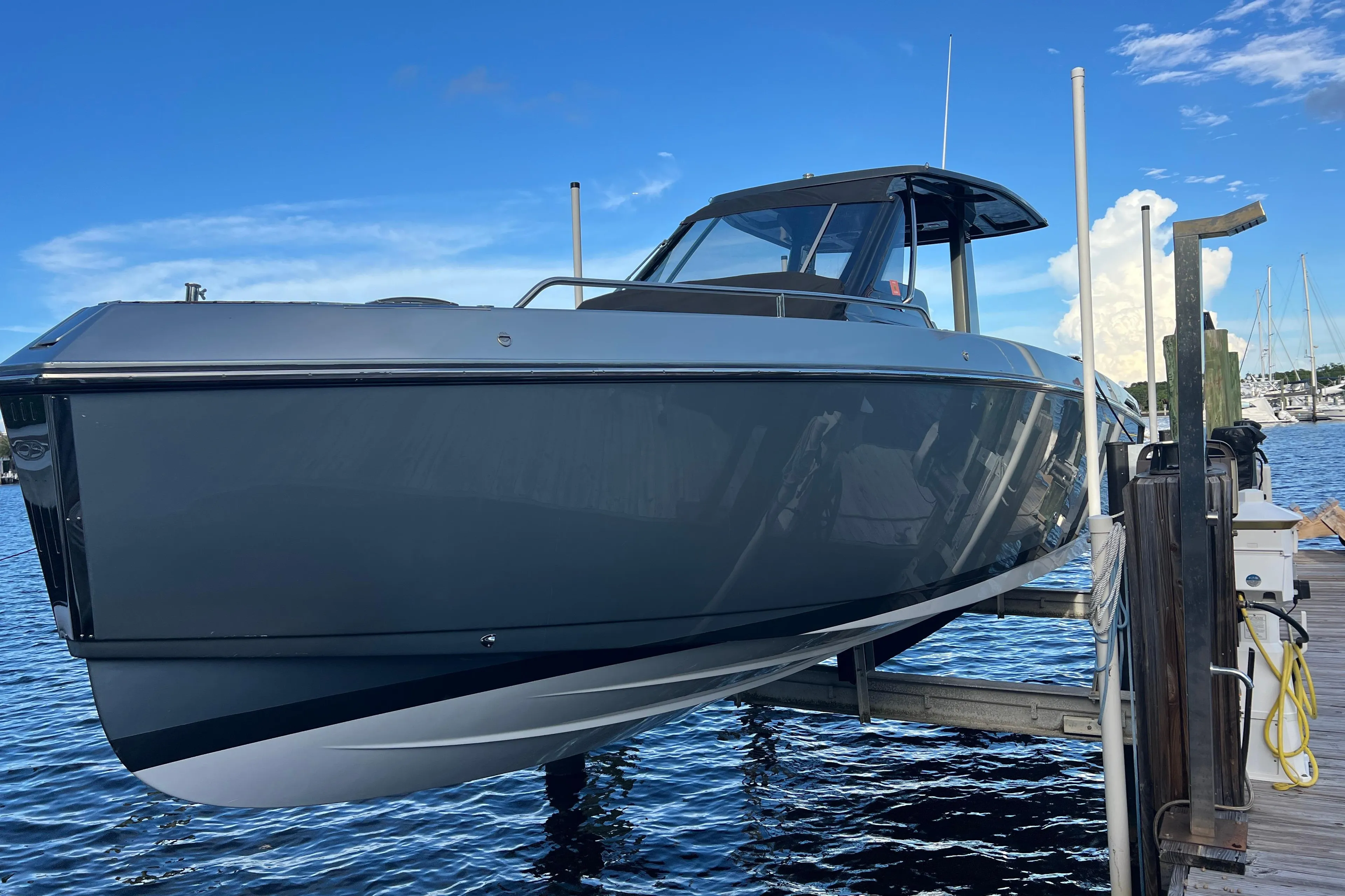 2023 Schaefer V33 boat docked, sleek design against a clear blue sky.