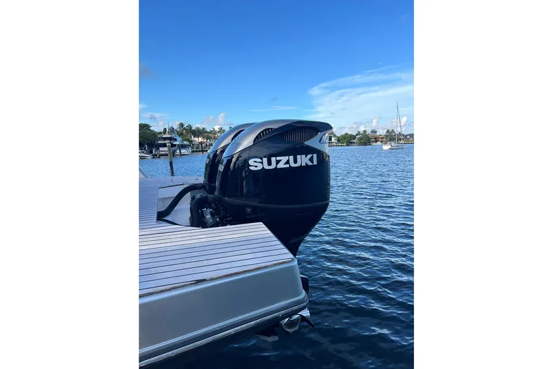  Yacht Photos Pics 2023 Schaefer V33 boat with Suzuki outboard motor on a calm waterfront.
